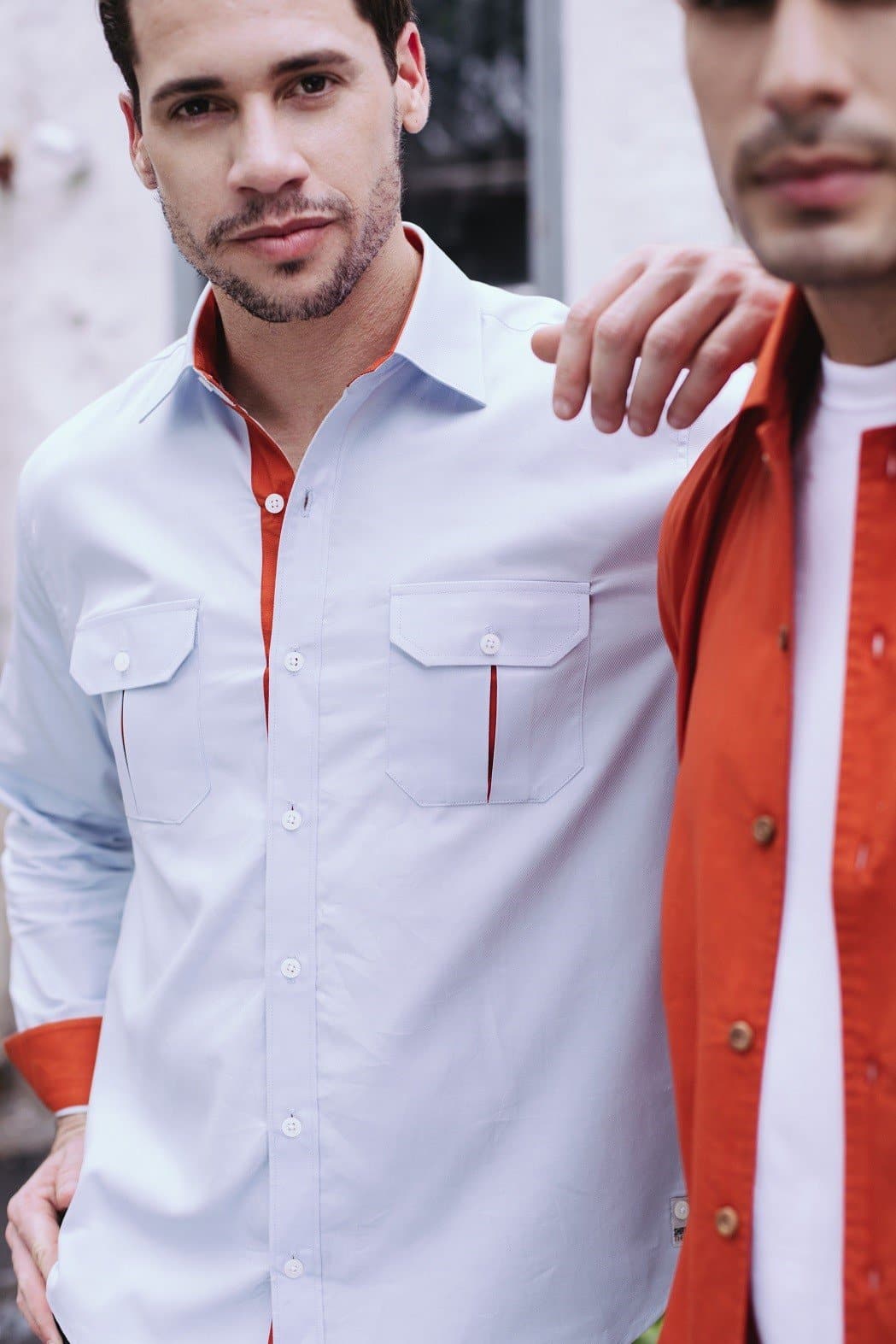 a couple of men standing next to each other